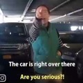 Woman steals parking space by standing.