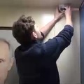 How Russians react to Putin's portrait put on an elevator