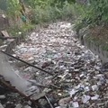 cleaning a river full of trash