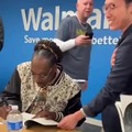 Snoop Dogg signing his autograph, in Japanese, at a Walmart