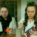 What is she doing to that orange?