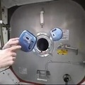 The difference in stability of a CD player that is turned off or on in microgravity