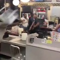 Employee catches chair thrown by customer